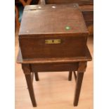 An early 19th century oak bible box on stand, set on block legs and with a further door that reveals