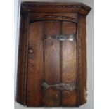*Item to be collected from Friargate, Derby* An Arts and Crafts oak wall hanging corner cupboard,