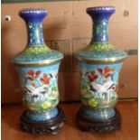 A group lot to include a pair of Cloisonné vases and a similar fruit bowl, all with wooden