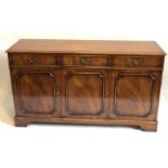A 19th century style mahogany sideboard, crossbanded top with moulding, three frieze draws with