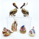 A collection of Royal Crown Derby paper weights, to include 3 birds, one of which is sat on a