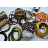 Two bags containing a large selection of vintage and contemporary bangles -in metal, wood and