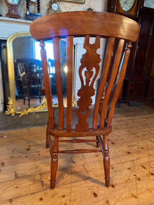 A 20th century elm and beech stained farmhouse armchair, pierced splat and spindle back, scrolling - Image 3 of 3