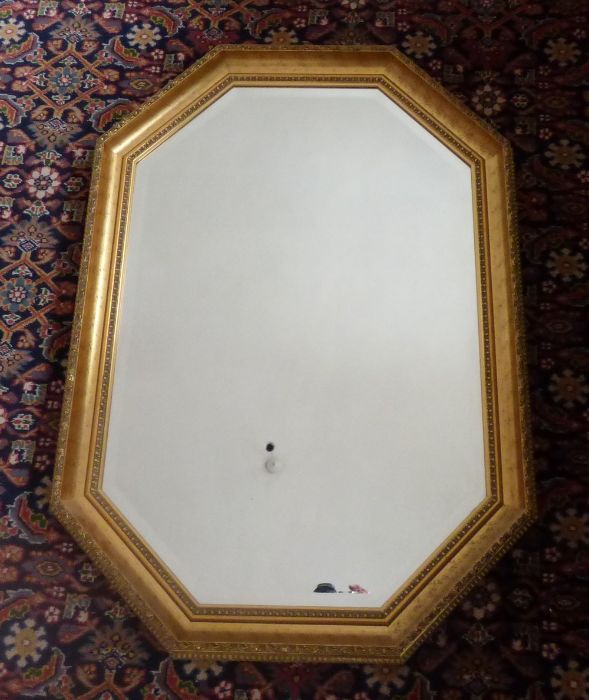 A canted rectangular wall mirror in gilt frame