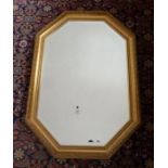 A canted rectangular wall mirror in gilt frame