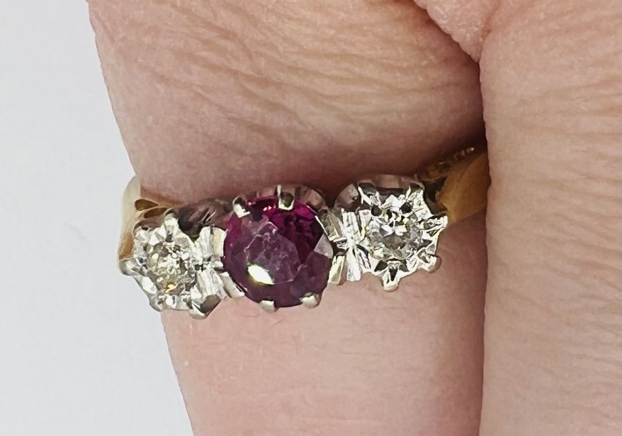 An 18ct gold ruby and diamond trilogy ring, along with a pair of ruby ear studs, stamped 375. The - Image 4 of 7