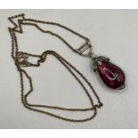 A diamond and garnet pendant in closed back yellow and white metal (please note denting to