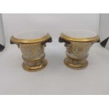 A pair of 19th century English porcelain pots on stands with gilt Acanthus leaf decoration.