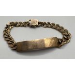 A yellow metal ID bracelet. Engraved with the name John. Stamped 14k to the clasp and the name