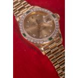 An 18 carat gold Rolex Oyster Perpetual DateJust ladies watch, set with diamonds and emeralds, with