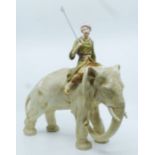 A Royal Dux model of an elephant and Mahout, the Mahout dressed in robes and carrying a lance,