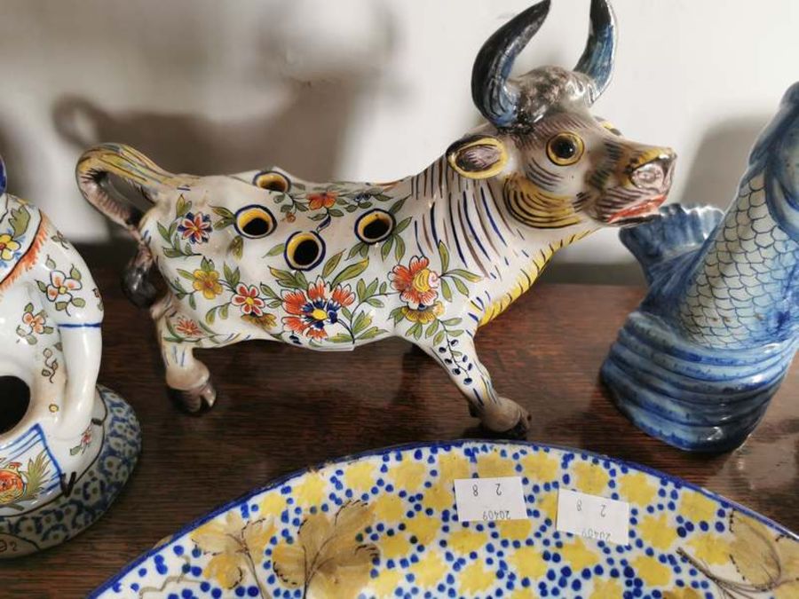 Three polychrome tin glazed chargers, a jug, bowl, a faience vase modelled as a cow, a faience - Image 3 of 4