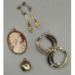 A selection of 9ct gold and yellow metal jewellery: A pair of unmarked earrings in yellow metal,