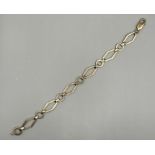 A geometric link bracelet, with patterning to alternate links. Stamped 9ct to one of the links and