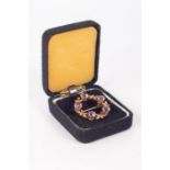 A 9ct gold amethyst wreath brooch. Gross weight approximately 5.1 grams. (1)