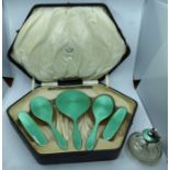 An Art Deco silver and green enamelled dressing table set comprising hand mirror , pair of