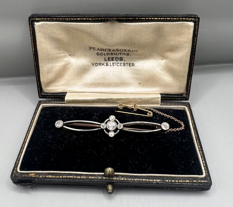 An Edwardian yellow and white metal diamond set brooch, central diamond old European cut,