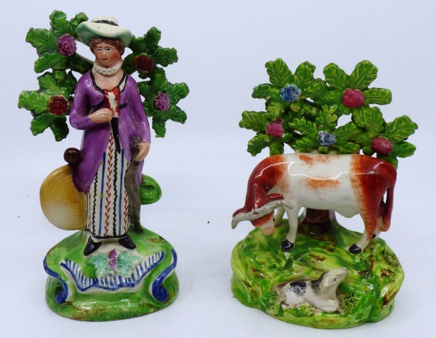 2 Staffordshire figures to include a cow and calf C1820 15.5cm high with some restoration to the