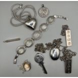 A selection of silver jewellery comprising two silver ingots on chains, a sterling silver key