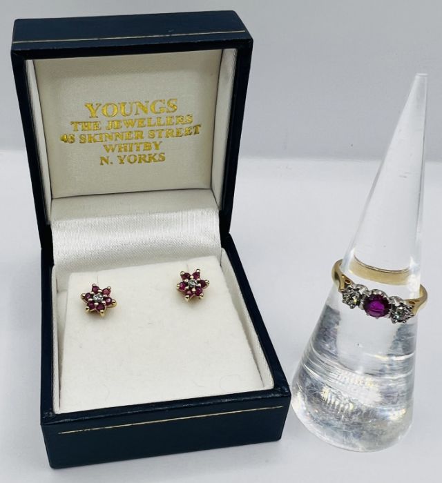 An 18ct gold ruby and diamond trilogy ring, along with a pair of ruby ear studs, stamped 375. The