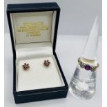 An 18ct gold ruby and diamond trilogy ring, along with a pair of ruby ear studs, stamped 375. The