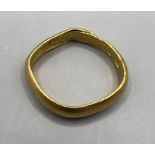 A yellow metal ring, in as found condition, marked with two panels containing Chinese characters.