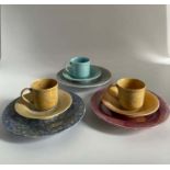 Three Ruskin Pottery lustre coffee cups and saucers, two yellow one blue. Marked Ruskin England