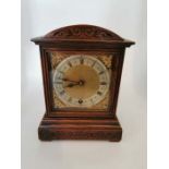 An Edwardian oak mantel clock, Winterhalder & Hofmeier wind up movement, square brass dial with cast