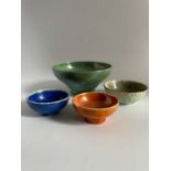 A group of four Ruskin Pottery bowls comprising: Miniature crystalline blue glaze bowl stamped