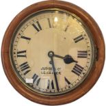 An early 20th century oak wall clock by Judge & Co Leicester, circular dial with Roman numerals,