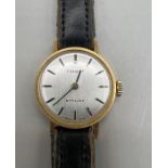 An 18ct gold Tissot Stylist ladies wrist watch. SIlvered dial with gold hands and baton interval