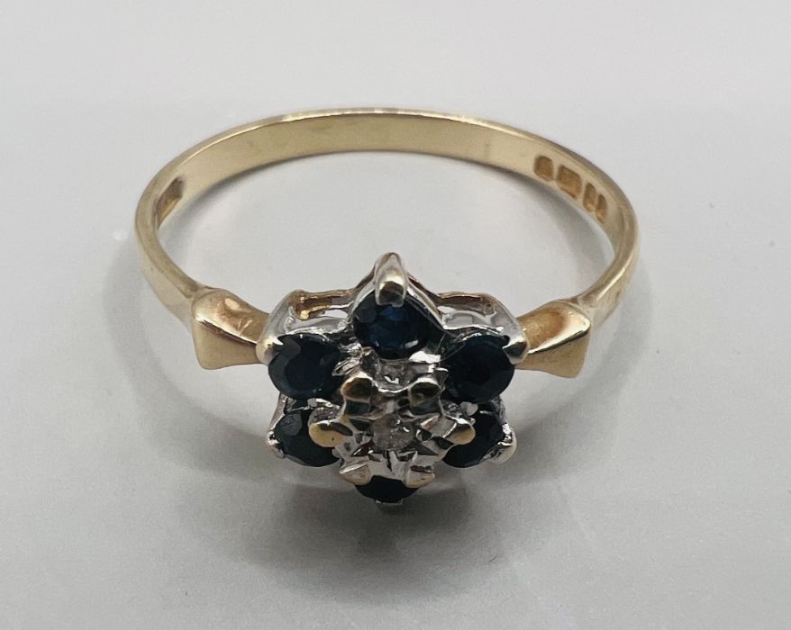A 9ct gold diamond and sapphire cluster ring. Size N. Gross weight approximately 1.6 grams.