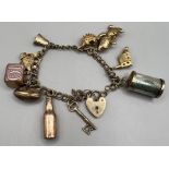 A 9ct gold charm bracelet comprising 11 charms plus padlock clasp. Gross weight approximately 24.4