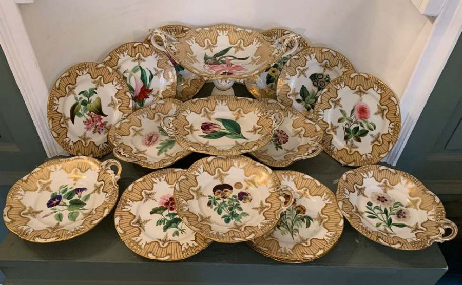 An early 19th century gilt and hand painted floral Staffordshire dessert set comprising of 20