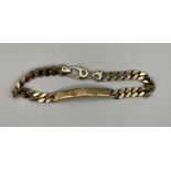 A gentleman's identity bracelet in 9ct gold, engraved "Robert J Morris" on one side and with a