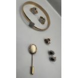 A selection of yellow metal jewellery items comprising three pairs of studs, a cubic zirconia set