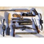 A collection of woodworlking tools to include chisels  gauges and spoke shaves