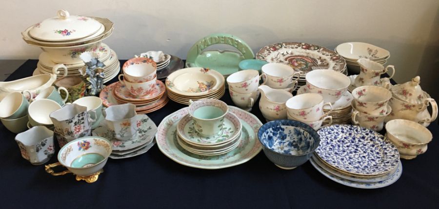 A large collection of porcelain items to include part tea sets and part dinner service, various