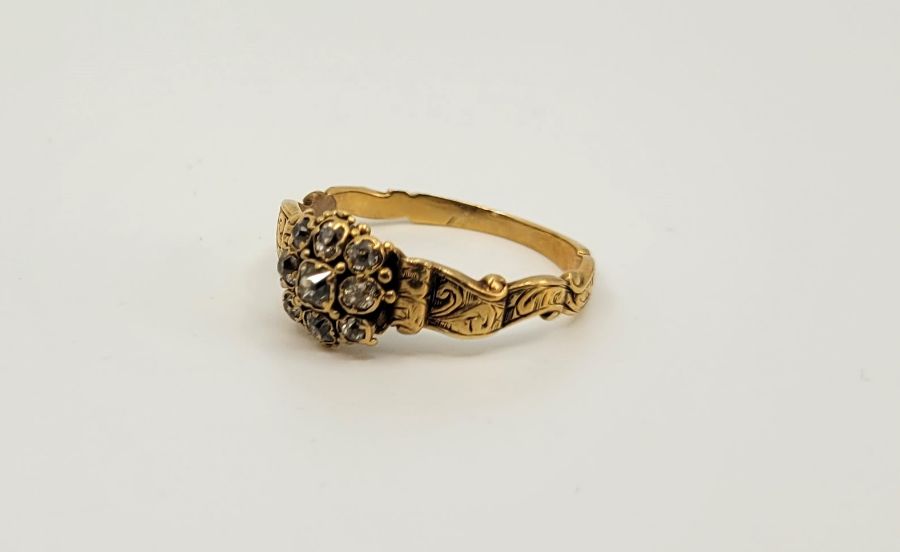 A 19th century precious yellow metal diamond cluster ring, set nine old-cut diamonds with engraved