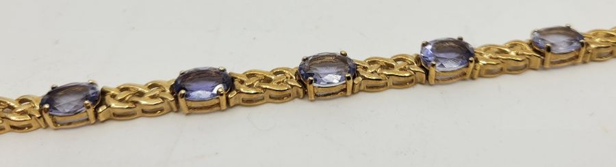 A 9ct. gold and tanzanite set bracelet, having eleven mixed oval cut tanzanites set links - Image 3 of 3