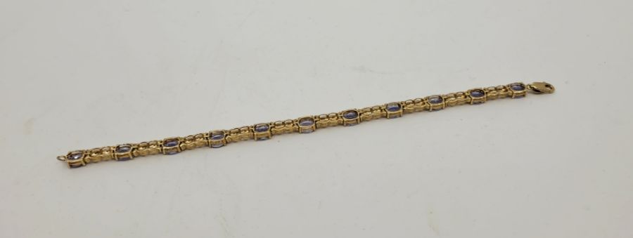 A 9ct. gold and tanzanite set bracelet, having eleven mixed oval cut tanzanites set links - Image 2 of 3