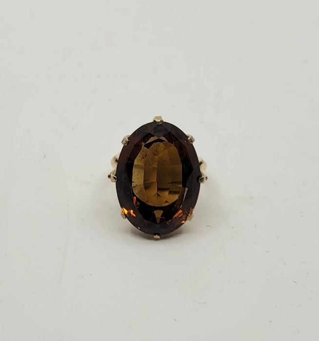 A 9ct. gold and citrine cocktail ring, London 1981, claw set large mixed cut citrine, approx. size - Image 2 of 4