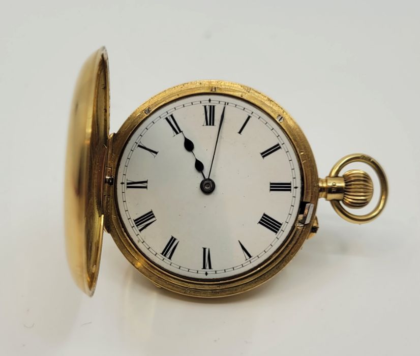 An 18ct. gold half hunter pocket watch, crown wind, having white enamel Roman numeral dial, 38mm