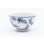A Meissen style blue and white pressed small tea bowl, decorated with flowers, blue crossed sword/