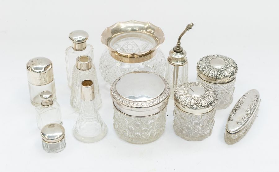 A small collection of silver rimmed or topped cut glass items to include; a fluted Birmingham silver