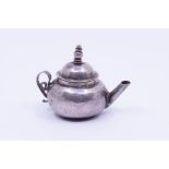 A Queen Anne Britannia silver miniature teapot, hammered body, detachable domed cover with knopped