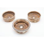 A pair of 19th Century silver plated wine coaster, gadroon borders, turned wooden bases, stamped