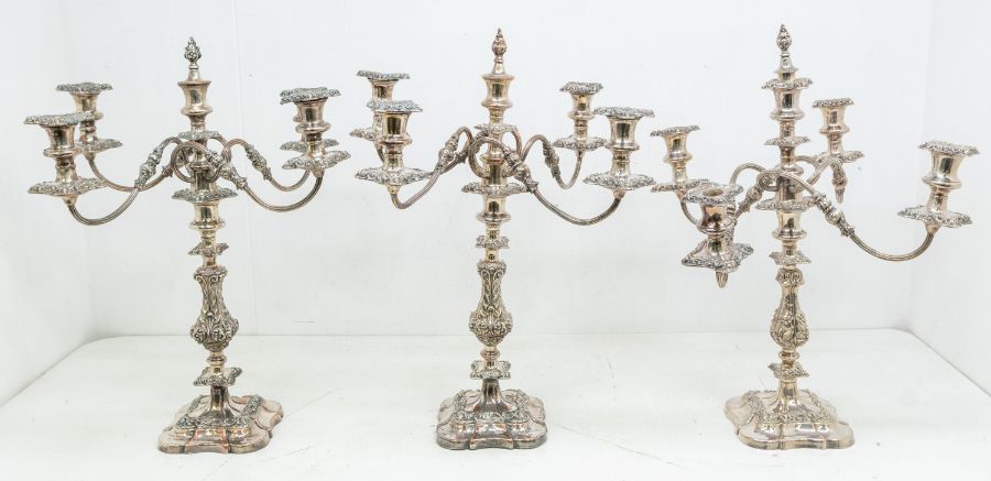 A set of three Victorian large four branch candelabra, detachable branches with reeded stems,