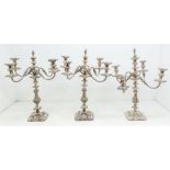 A set of three Victorian large four branch candelabra, detachable branches with reeded stems,