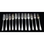 A matched set of twelve George III silver Hanoverian pattern table forks, each engraved with a
